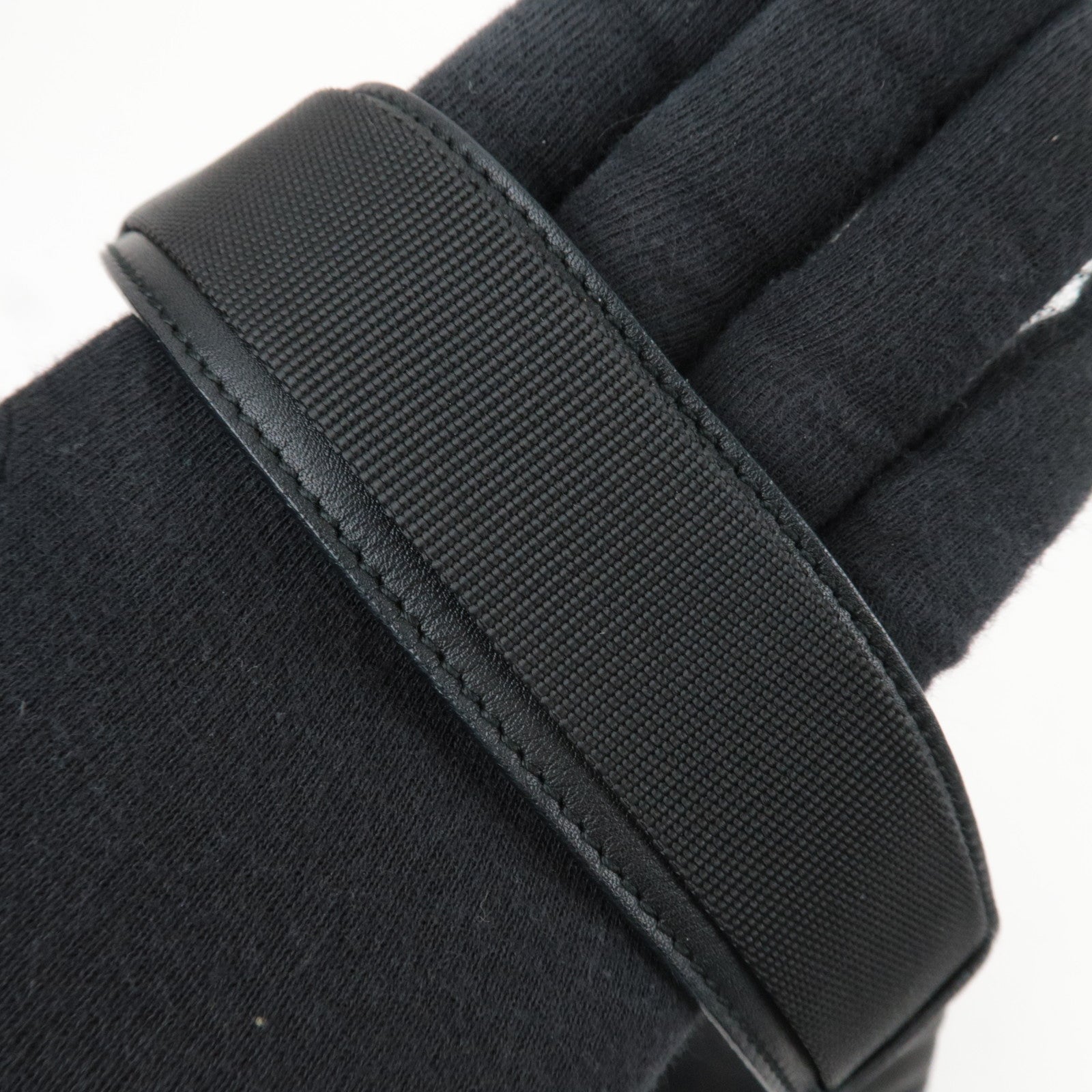 Detail of strap on Ferragamo Gancini Shoulder Bag Canvas Leather Black showing texture and finish.