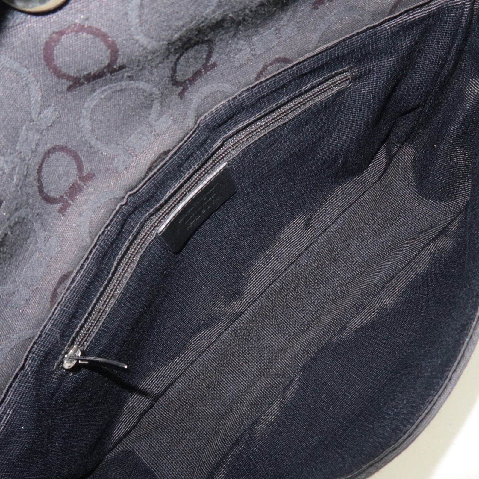 Interior view of Ferragamo Gancini Shoulder Bag Canvas Leather Black showing lining and zippered pocket.